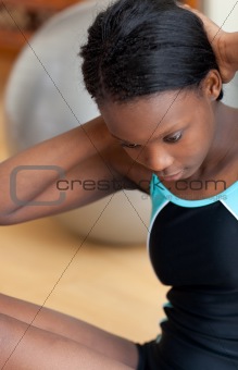 Attractive woman in gym outfit doing sit-ups