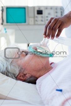 A doctor putting oxygen mask on a patient