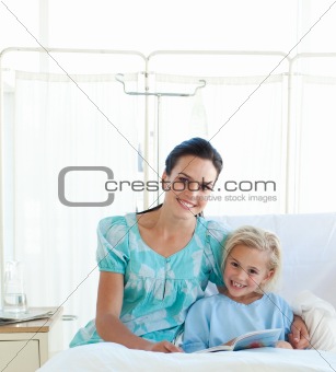 Attentive mother reading with her daughter