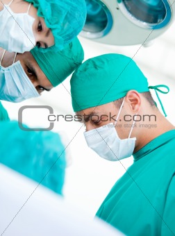Multi-ethnic madical team working on a patient 