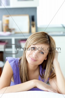 Delighted woman eating looking at the camera in the kitchen 