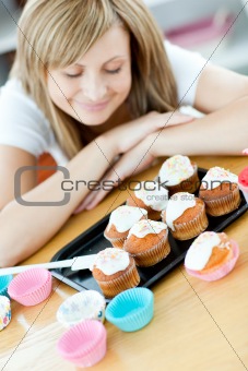 Caucasian woman preparing cakes in the kitchen