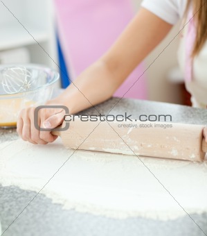 Smiling woman preparing a cake the kitchen 