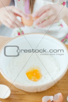 Delighted woman preparing a cake in the kitchen 