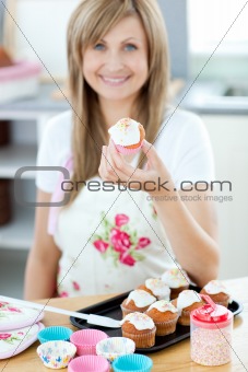 Caucasian woman preparing a cake in the kitchen at home