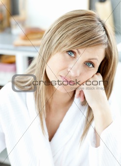 Teen woman looking at the camera in the kitchen