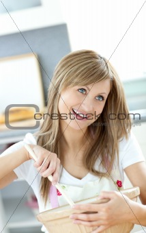 Teen woman preparing a cake in the kitchen