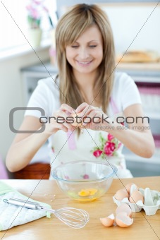 Caucasian woman preparing a cake in the kitchen at home