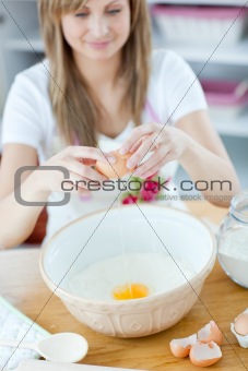 Radiant woman preparing a cake in the kitchen