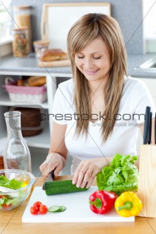 Delighted woman preparing a healthy meal in the kitchen 
