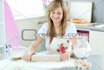 Portrait of an attractive woman preparing a cake in the kitchen