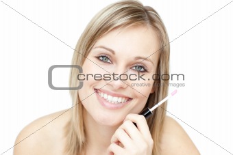 Portrait of an attractive woman holding a lipstick