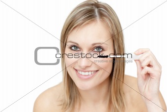 Bright woman putting mascara 