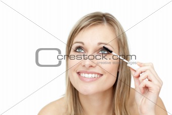 Jolly woman putting mascara 