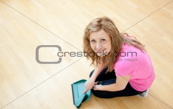 Smiling young woman cleaning the floor 