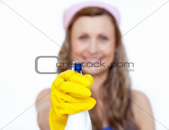 Smiling young woman cleaning against a white background