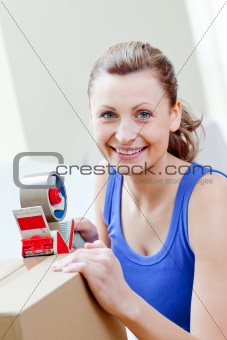 Radiant woman packing boxes in the living-room
