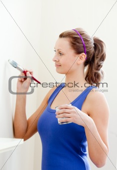 Beautiful woman is decorating a room 