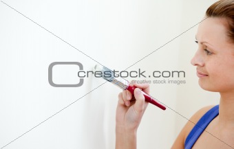 Cute woman is decorating a room 