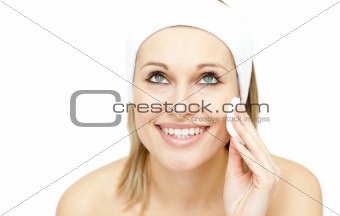Beautiful woman putting foundation cream