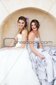 Young Women in Gowns and Sitting in an Alcove