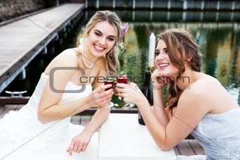 Young Women in Gowns Sharing a Drink