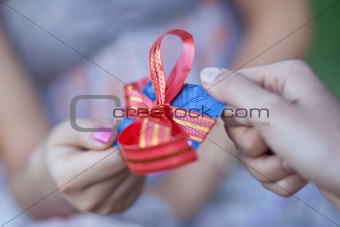 Credit card with a bow in a gift to the young woman. Small depth