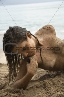 Topless woman on beach.