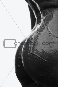 Muddy nude female buttocks.