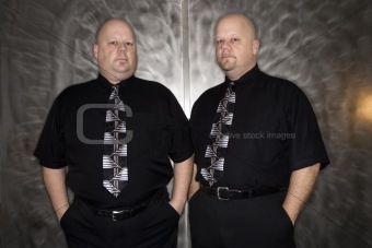 Twin bald men.