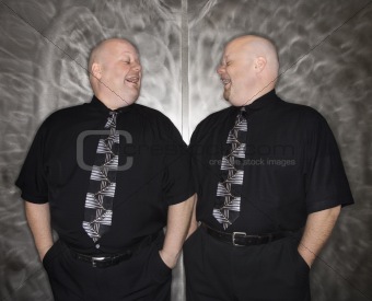 Twin bald men laughing.