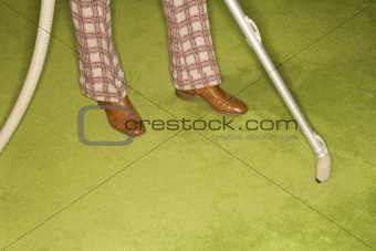 Man vacuuming rug.