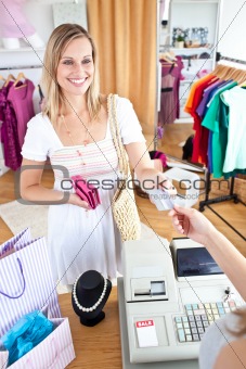 Caucasian woman is paying items 