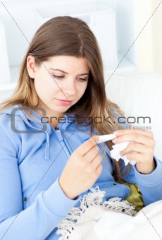 Sick young woman with a thermometer