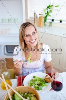 Positive young woman eating a salad