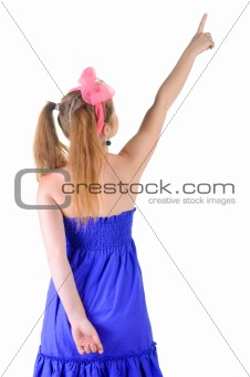 Young teenager girl points at wall.