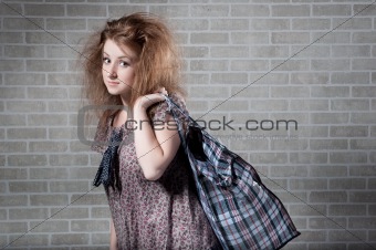 Tired redhaired woman with shopping bag. 