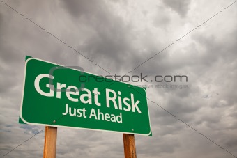 Great Risk Just Ahead Green Road Sign with Dramatic Storm Clouds and Sky.