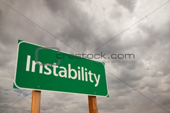 Instability Green Road Sign with Dramatic Storm Clouds and Sky.