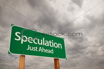 Speculation Just Ahead Green Road Sign with Dramatic Storm Clouds and Sky.