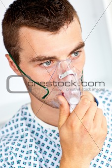 Serious male patient with a mask looking to the side