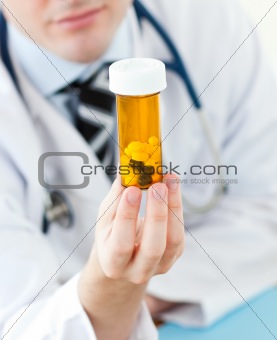 Young doctor holding pills