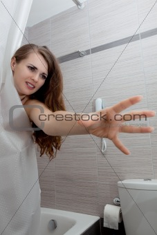 beautiful woman in bathroom streching for something