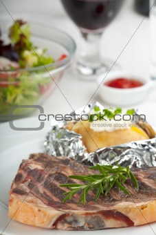 grilled steak and a rosemary leaf