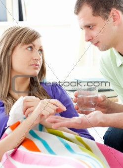 Loving boyfrieng giving his sick girlfriend pills