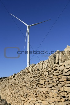 Electric windmills with a masonry rural wall 