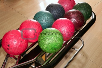 Bowling balls red green closeup row