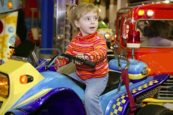 blond little girl in funfair fairground attraction
