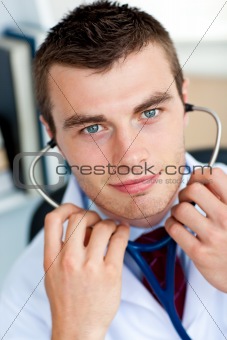 Portrait of an self-assured male doctor holding a stethoscope