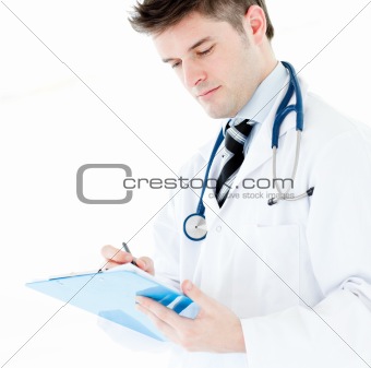 Portrait a charming male doctor writing notes against a white background